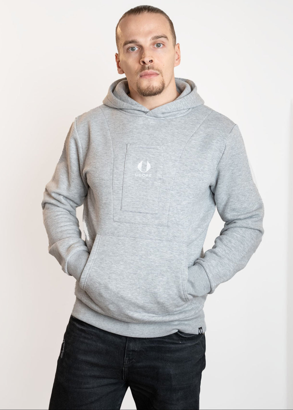 male model wearing a grey men's hoodie designed by ucore
