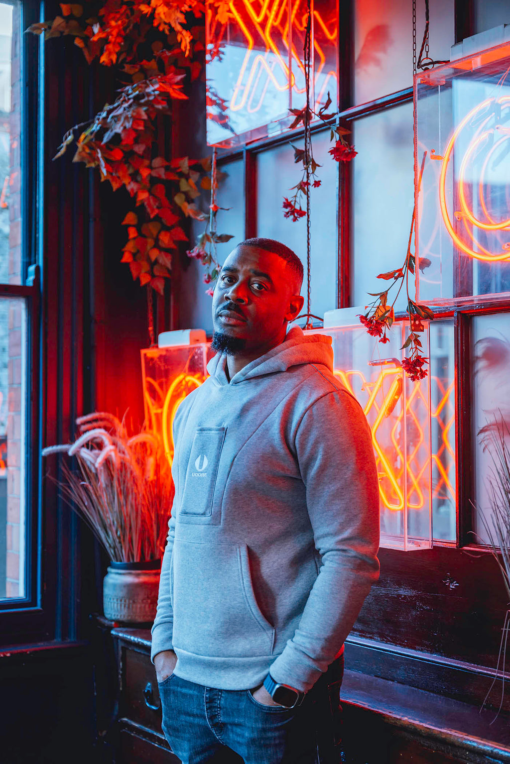 man standing and wearing grey ucore hoodie