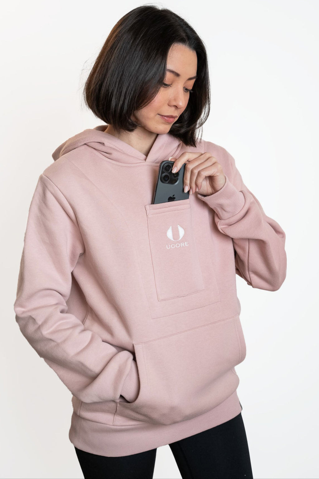 model placing phone back in central central hoodie pocket