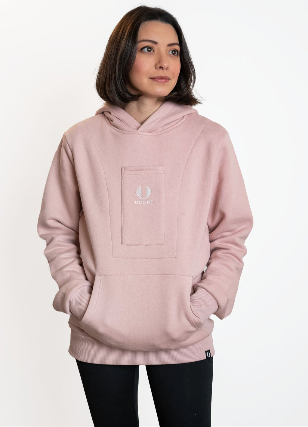 a dusky pink ucore women's hoodie being worn by model